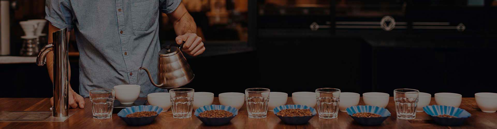 Barista-Pouring-Water-Cupping-Table