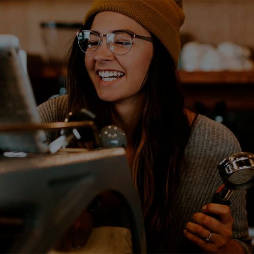 Woman Ski Mask Mustard Coffee Machine Smile Frontal